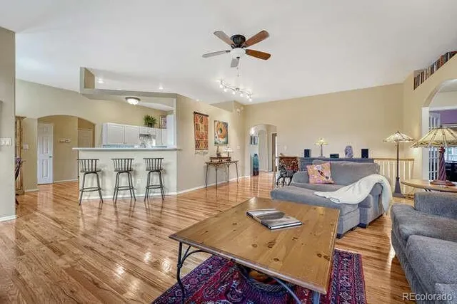a living room with furniture and a wooden floor