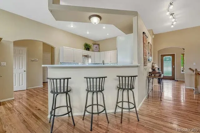 a kitchen with stainless steel appliances granite countertop a refrigerator and a stove top oven