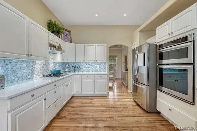 a kitchen with a white stove top oven and cabinets
