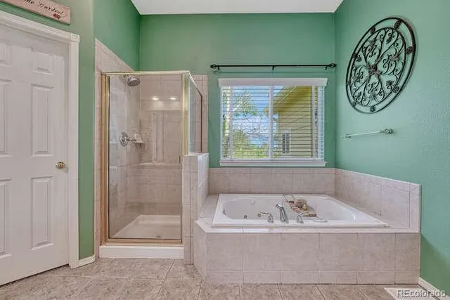 a bathroom with a granite countertop tub sink and mirror