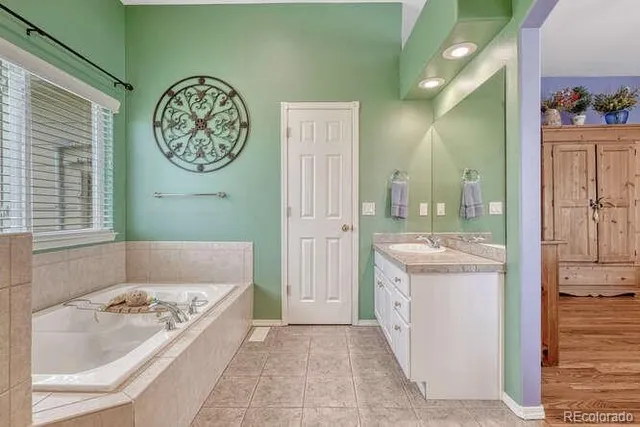 a spacious bathroom with a double vanity sink and a mirror