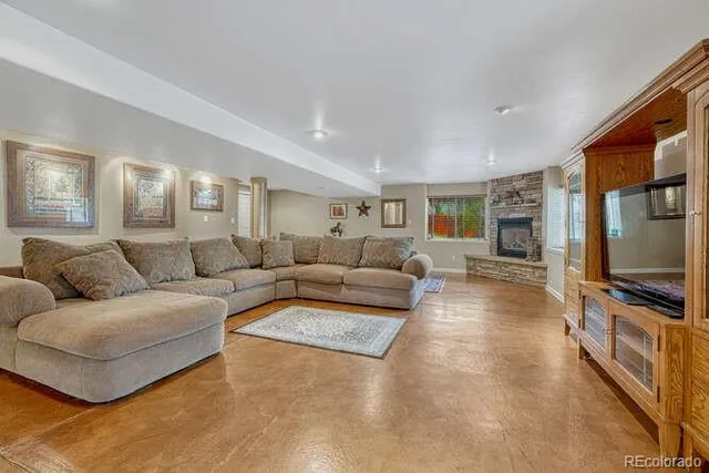 a living room with furniture and a fireplace