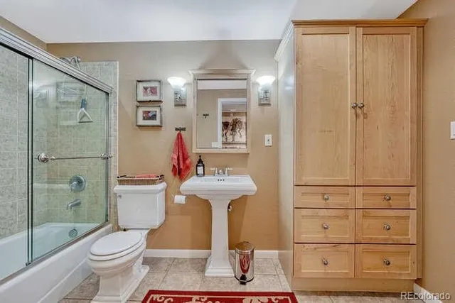 a bedroom with furniture and a lamp