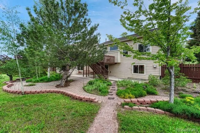 a view of backyard of house with green space