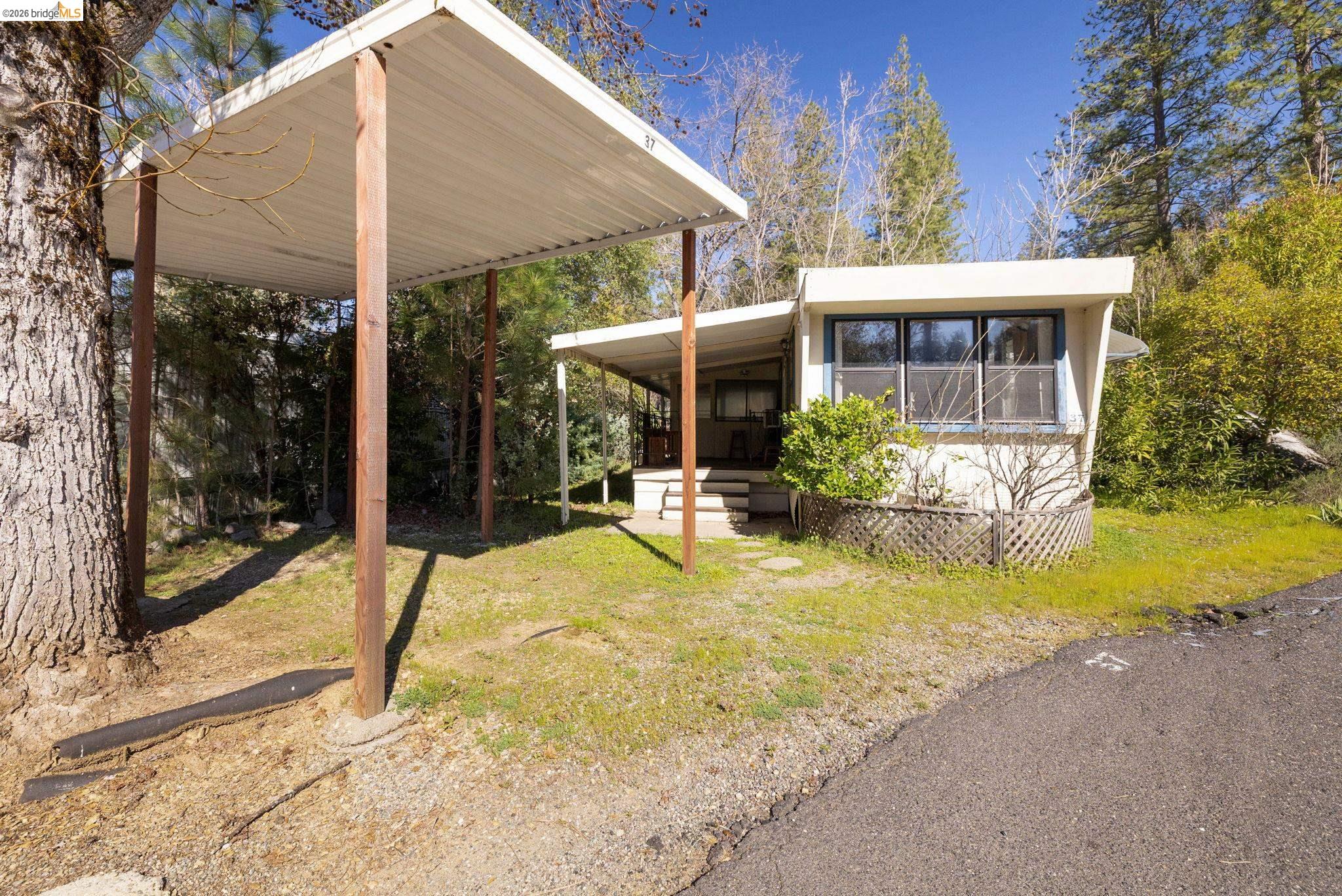 2216 Parrotts Ferry Road, Unit 37 Sonora, CA 95370 - Photo 1 of 1 a view of a house with backyard porch and sitting area