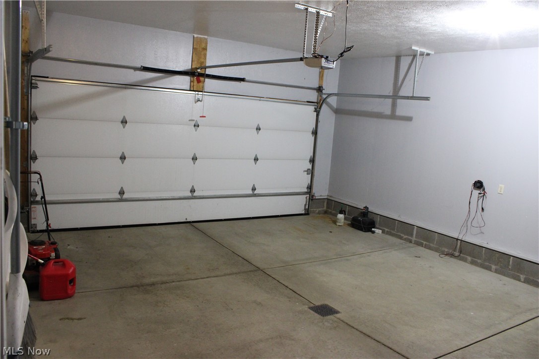 202 Home Street Rittman, OH 44270 - Photo 43 of 47 White panel garage door with automatic opener and concrete flooring