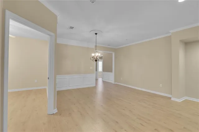 a living room with furniture and a large window with kitchen view