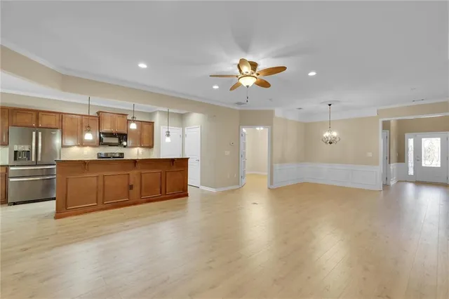 a kitchen with stainless steel appliances kitchen island a refrigerator and a sink