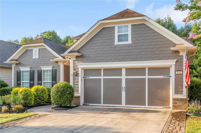 a view of hallway with window and hardwood floor