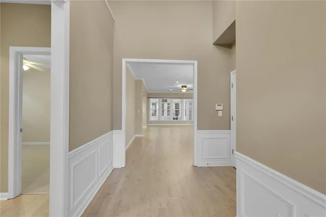 a living room with furniture a rug kitchen view and a chandelier