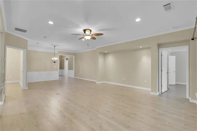 an empty room with cabinet and windows