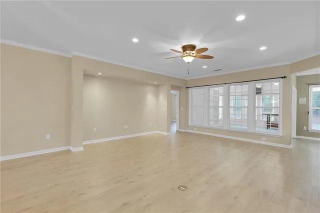 a view of a room with wooden floor and window