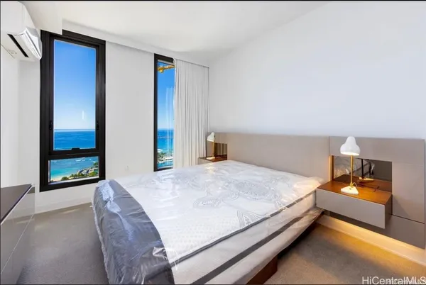 a bed sitting in a bedroom and table