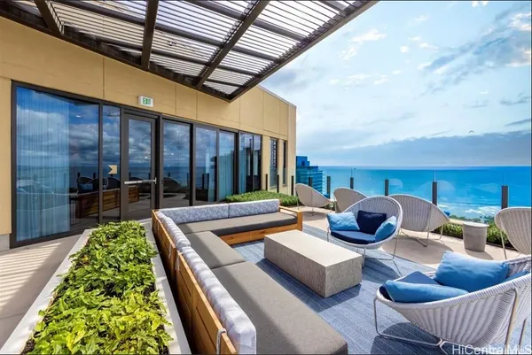 a outdoor space with patio couch and a fireplace