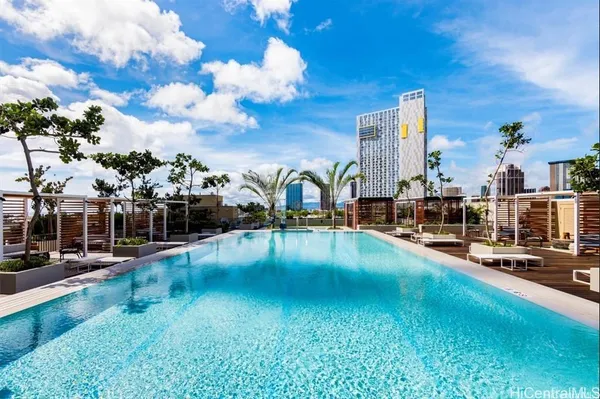 a view of a swimming pool with outdoor seating