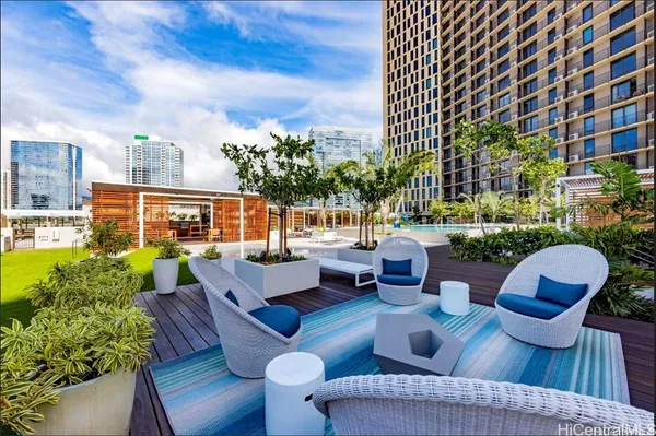 a view of a patio with couches table and chairs and potted plants