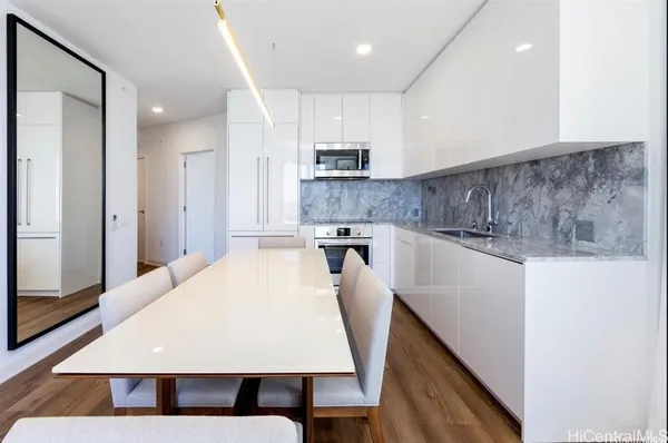 a large kitchen with kitchen island a sink stainless steel appliances and cabinets