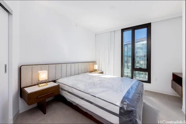 a bed room with a bed and a window