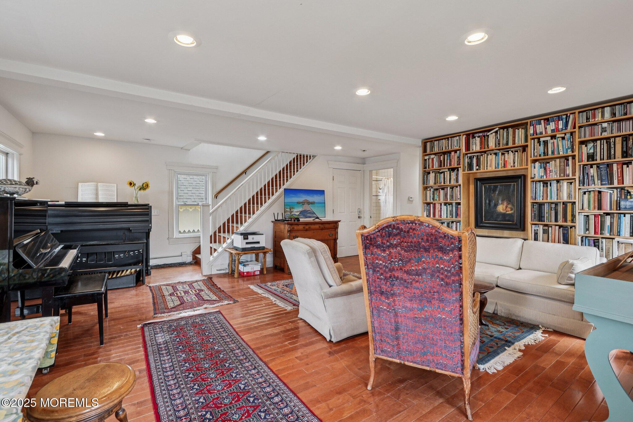60 Lake Avenue Ocean Grove, NJ 07756 - Photo 24 of 66 a living room with furniture a piano and a bookshelf
