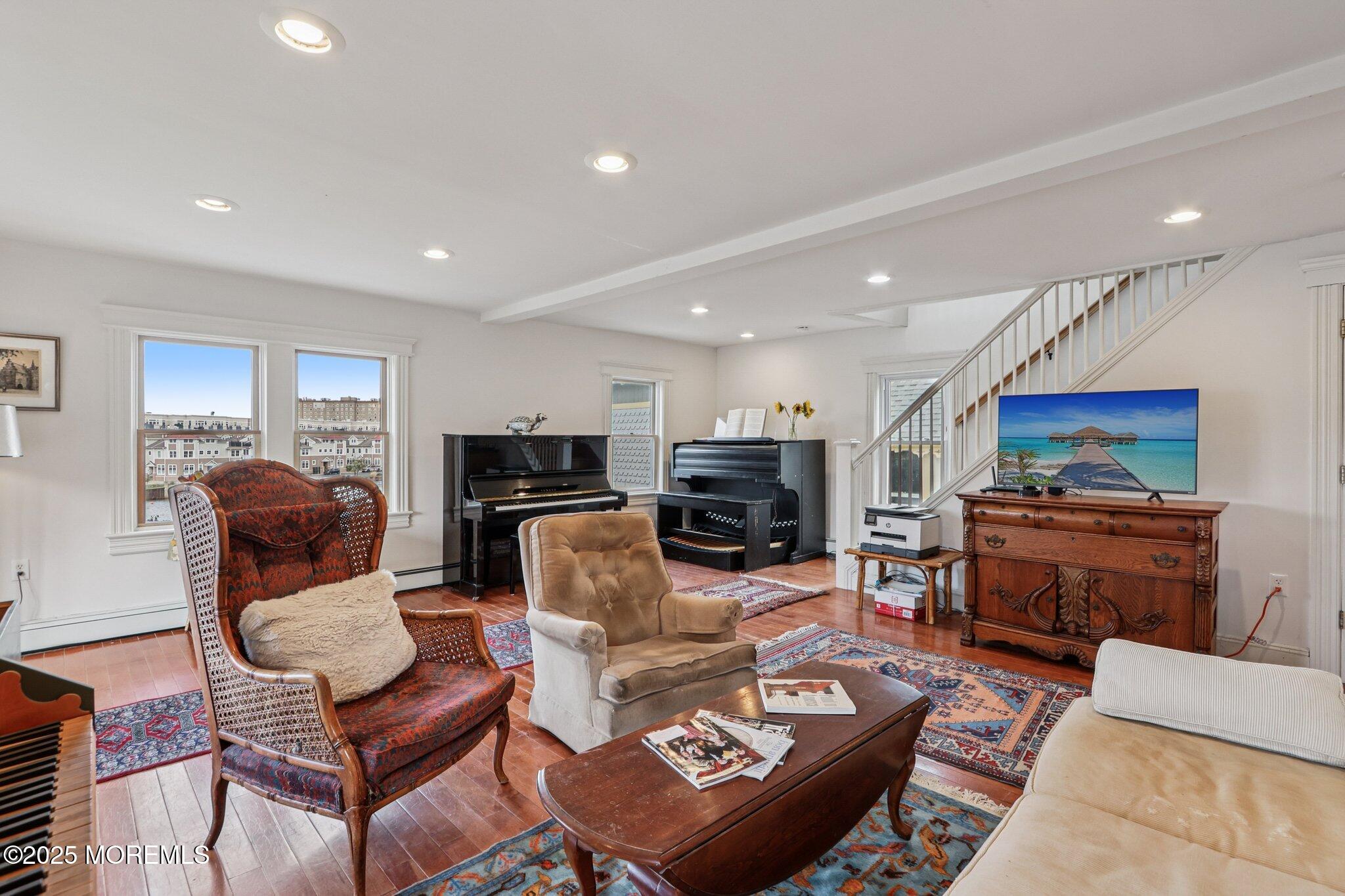 60 Lake Avenue Ocean Grove, NJ 07756 - Photo 25 of 66 a living room with furniture a flat screen tv and kitchen view