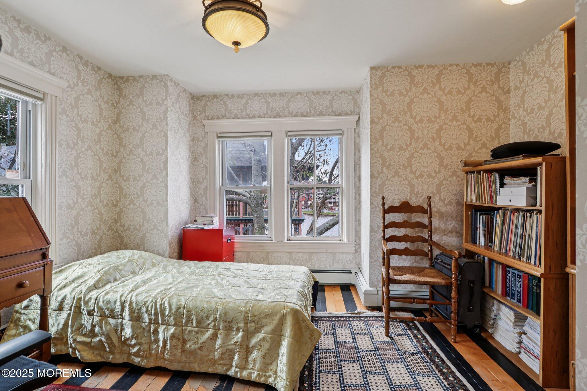 60 Lake Avenue Ocean Grove, NJ 07756 - Photo 36 of 66 a bedroom with a bed and a book shelf