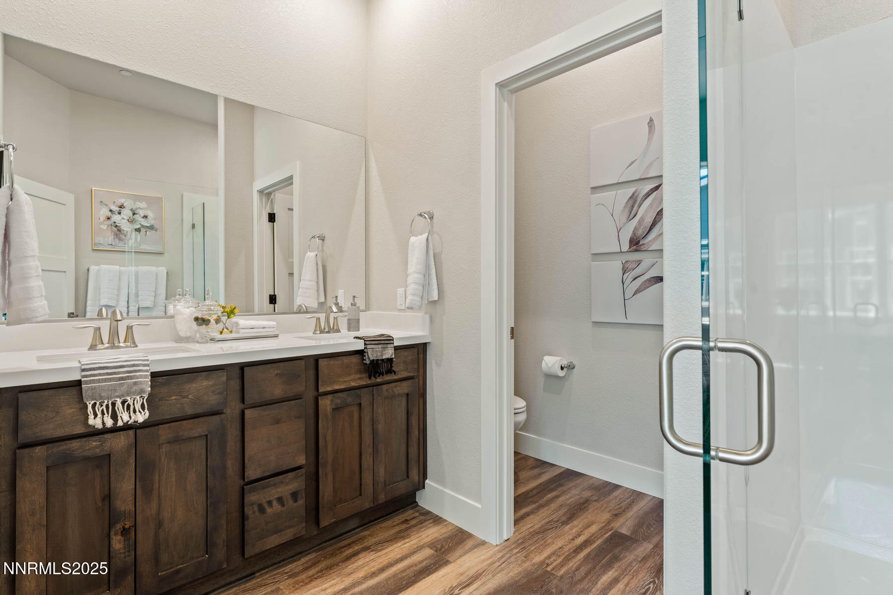 150 East Roland Street, Unit BLDG 1803 Carson City, NV 89701 - Photo 17 of 18 a bathroom with a double vanity sink a mirror and a shower