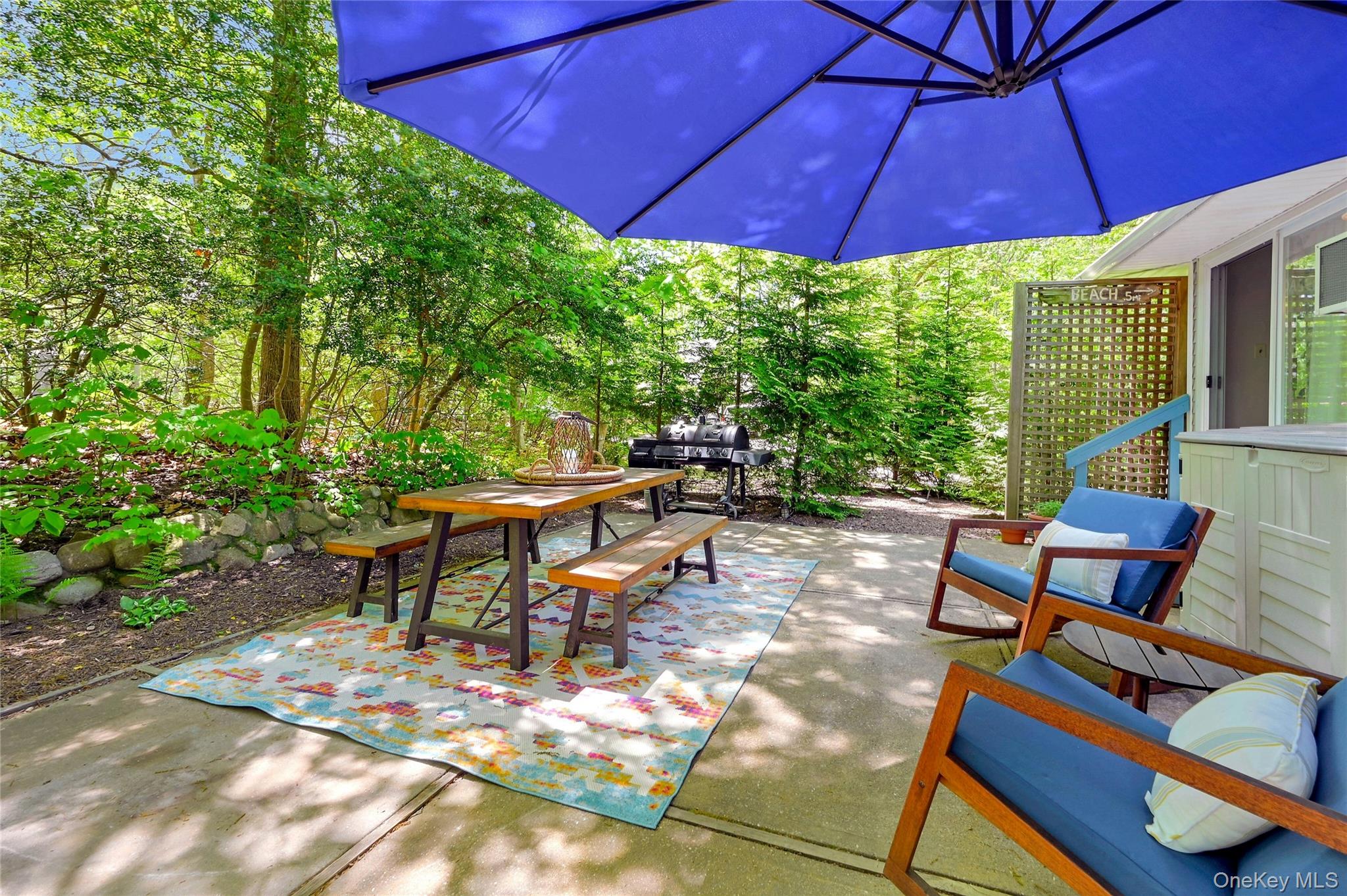 340 Pine Road Southold, NY 11971 - Photo 15 of 23 a view of a patio with table and chairs under an umbrella