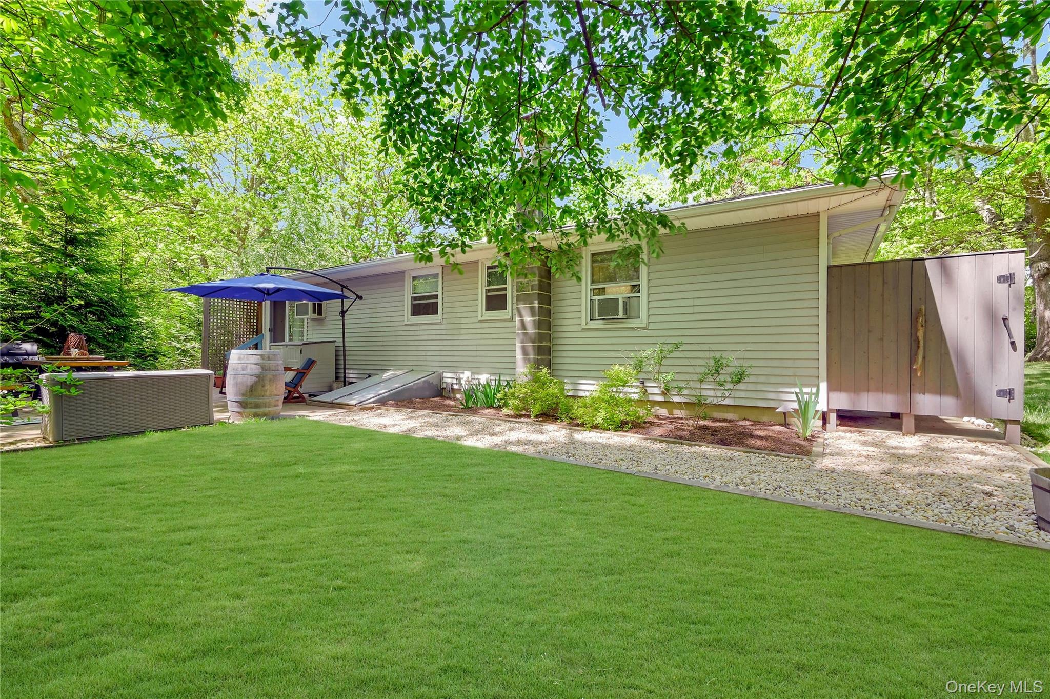 340 Pine Road Southold, NY 11971 - Photo 16 of 23 a backyard of a house with table and chairs