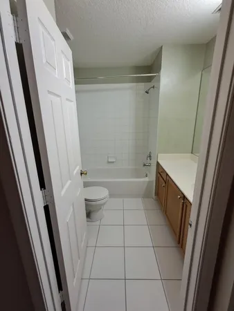 a bathroom with a sink a toilet a tub and shower