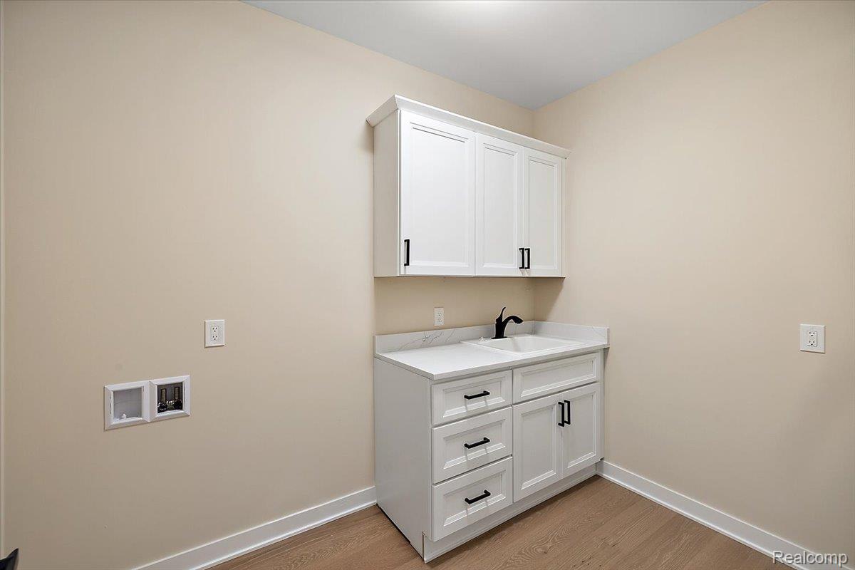 2044 Breckenridge Court Rochester, MI 48309 - Photo 22 of 33 Laundry room with light wood-type flooring and washer hookup