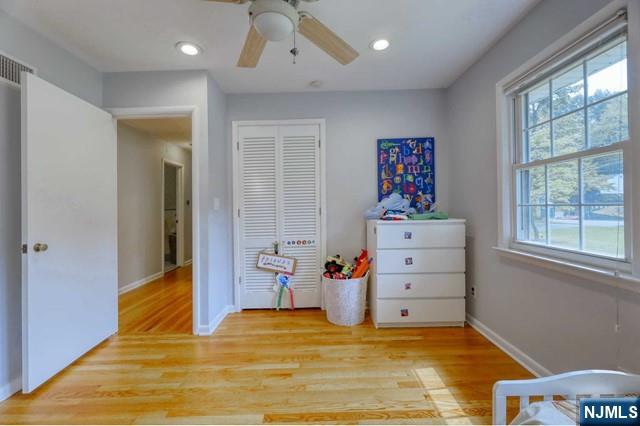 230 Pinelynn Road Glen Rock, NJ 07452 - Photo 9 of 19 a view of a bedroom with baby bed cabinet and a window