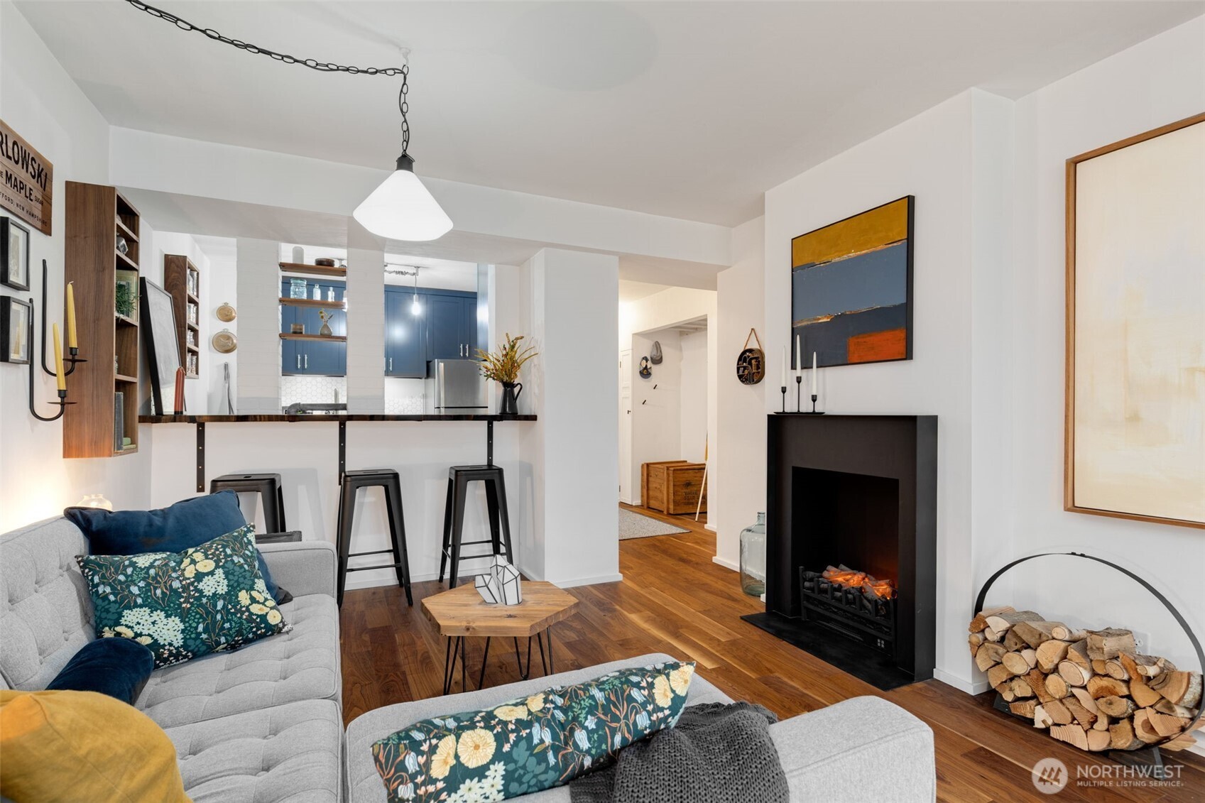 308 East Republican Street, Unit 513 Seattle, WA 98102 - Photo 5 of 40 a living room with furniture a flat screen tv and a fireplace