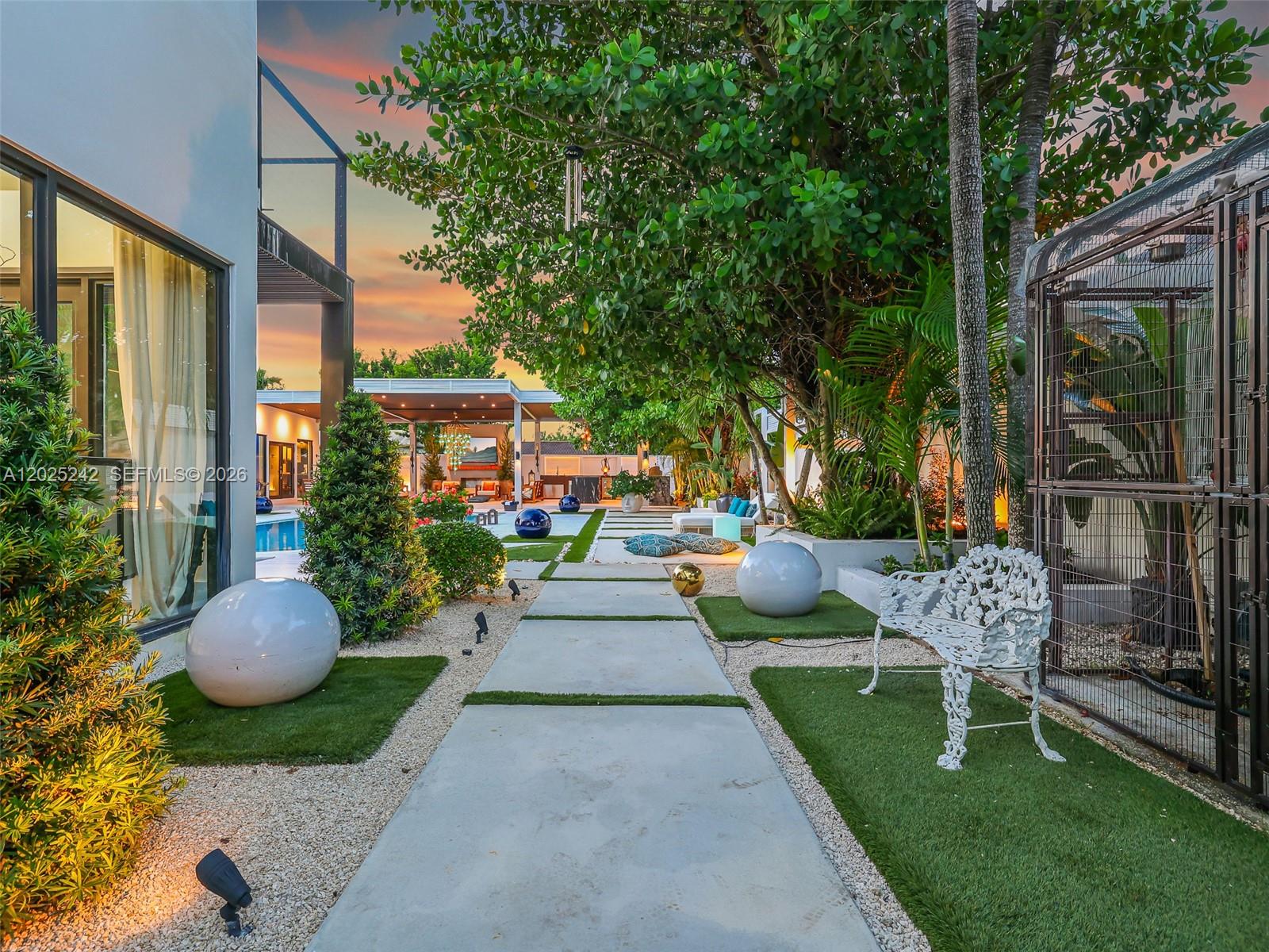 8761 Southwest 56th Street Miami, FL 33165 - Photo 89 of 90 a view of a patio with couches table and chairs and potted plants