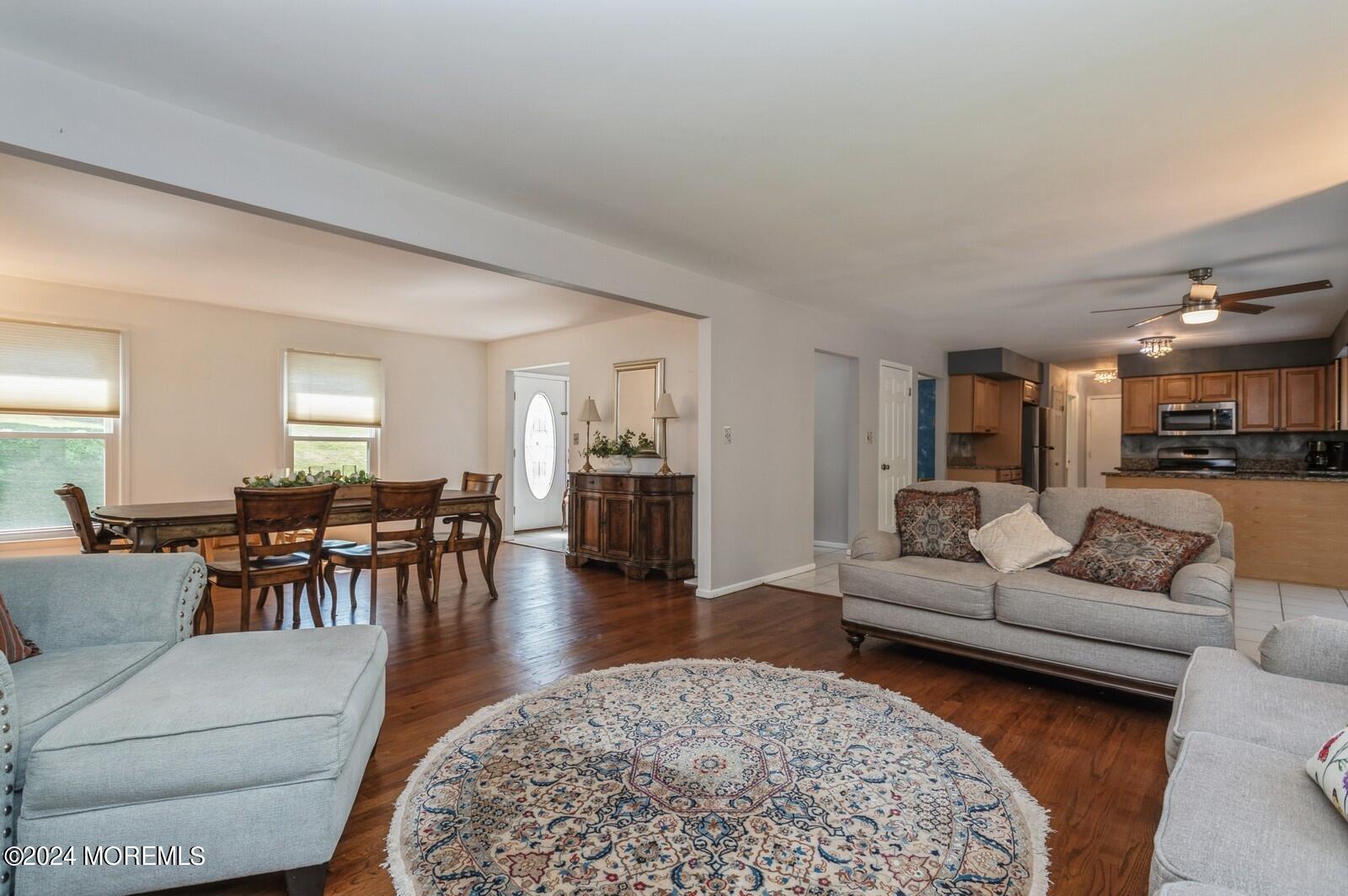 212 Nottingham Road Morganville, NJ 07751 - Photo 14 of 24 a living room with furniture and a dining table with wooden floor