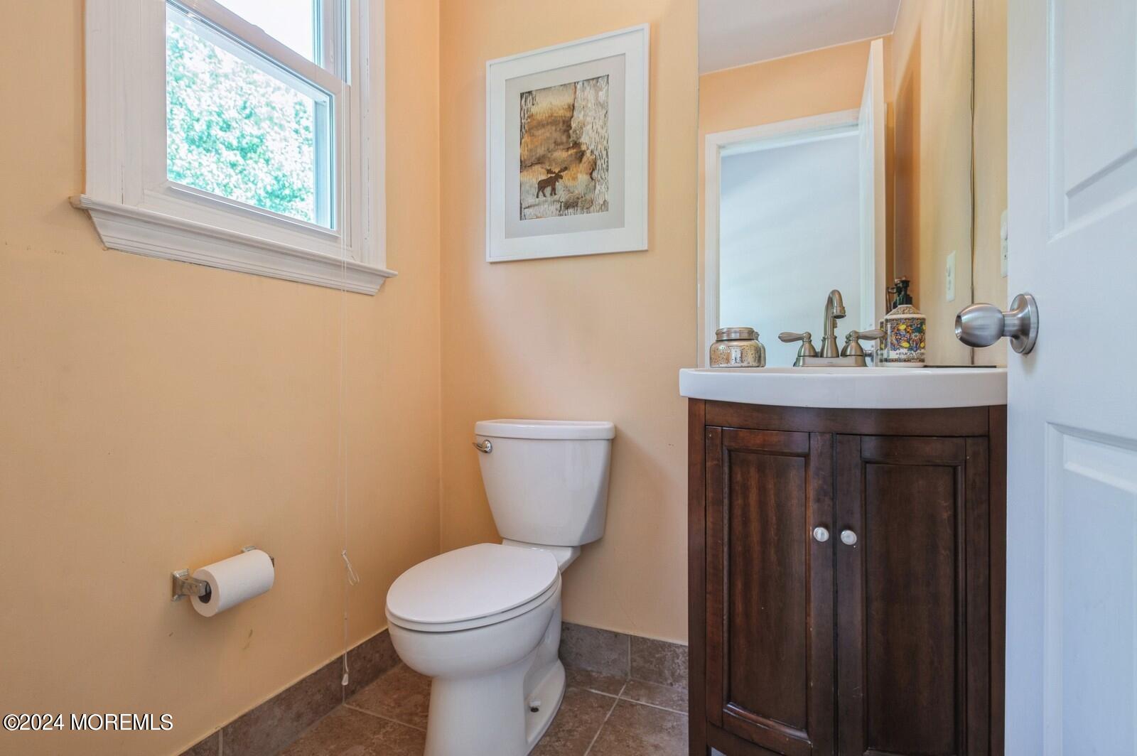 212 Nottingham Road Morganville, NJ 07751 - Photo 21 of 24 a bathroom with a toilet a sink and mirror