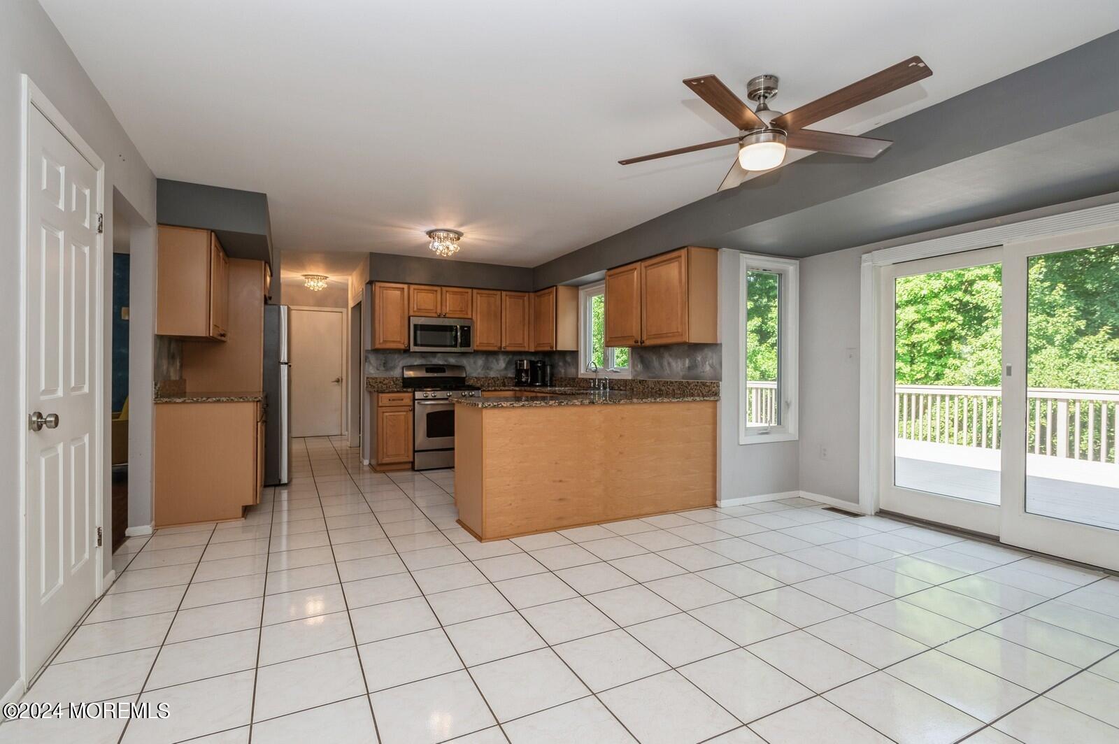 212 Nottingham Road Morganville, NJ 07751 - Photo 9 of 24 a kitchen with stainless steel appliances granite countertop a refrigerator oven a sink dishwasher and a open refrigerator