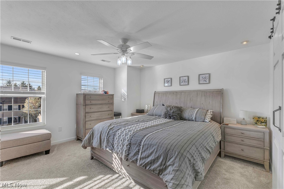 28340 Center Ridge Road, Unit 124 Westlake, OH 44145 - Photo 21 of 37 Bedroom featuring light colored carpet, ceiling fan, and recessed lighting