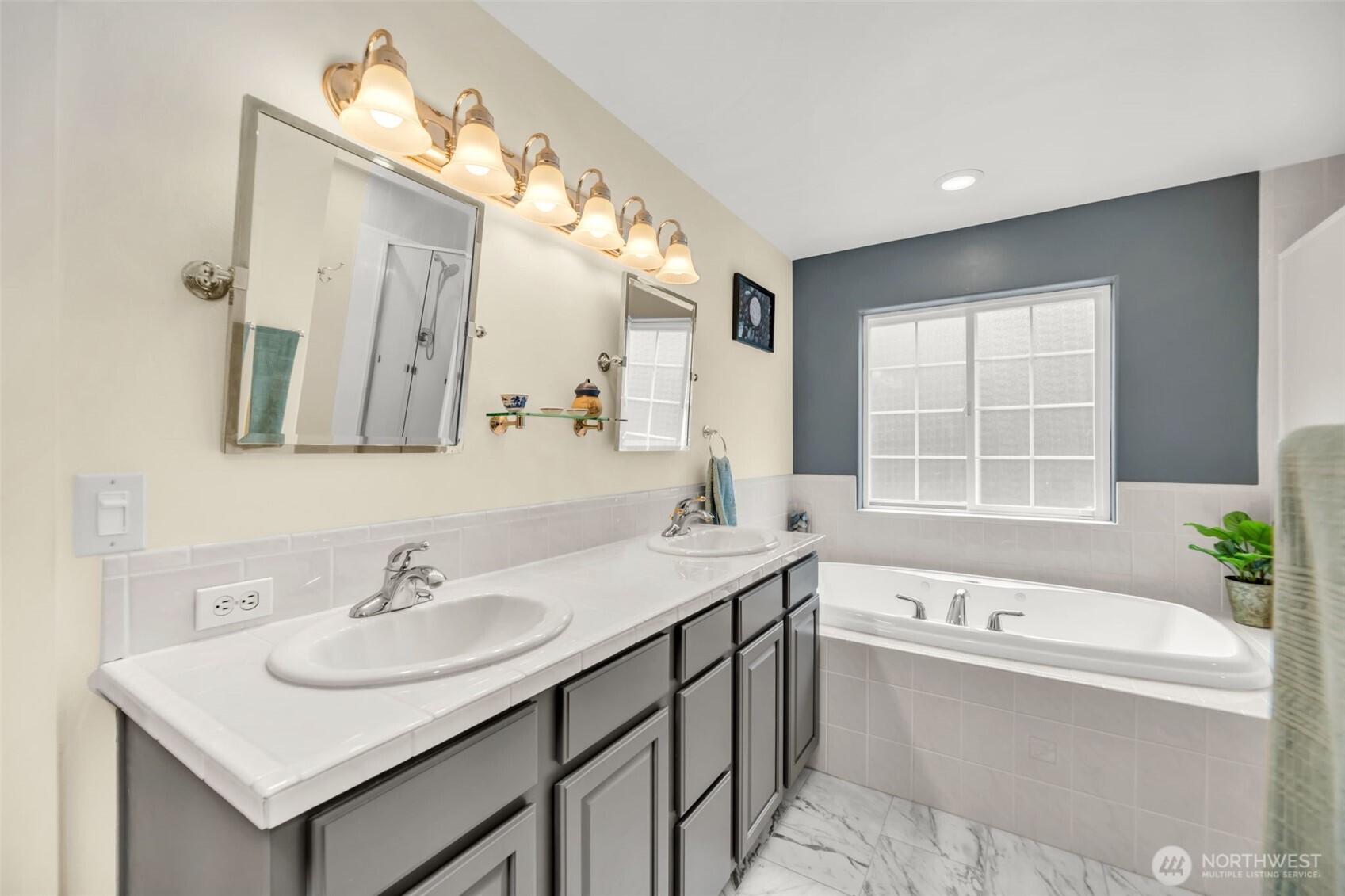 18005 252nd Avenue Southeast Maple Valley, WA 98038 - Photo 17 of 40 a bathroom with a tub sink and mirror