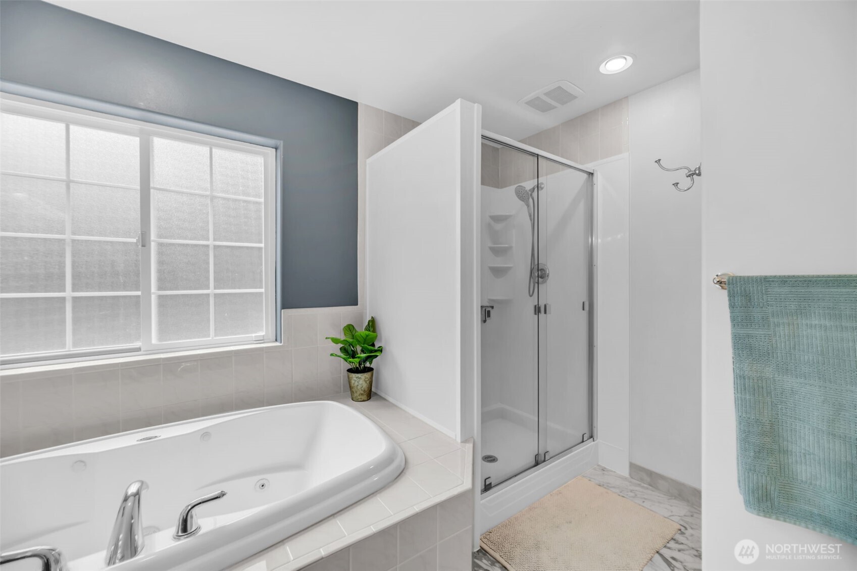 18005 252nd Avenue Southeast Maple Valley, WA 98038 - Photo 18 of 40 a bathroom with a tub and shower