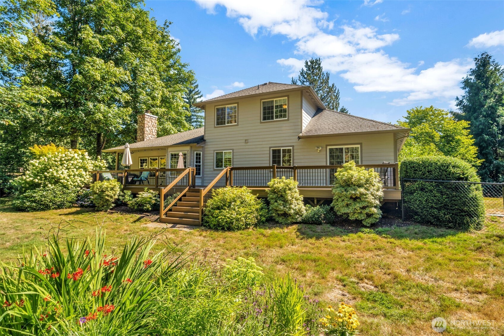 18005 252nd Avenue Southeast Maple Valley, WA 98038 - Photo 30 of 40 a view of a house with a yard and potted plants