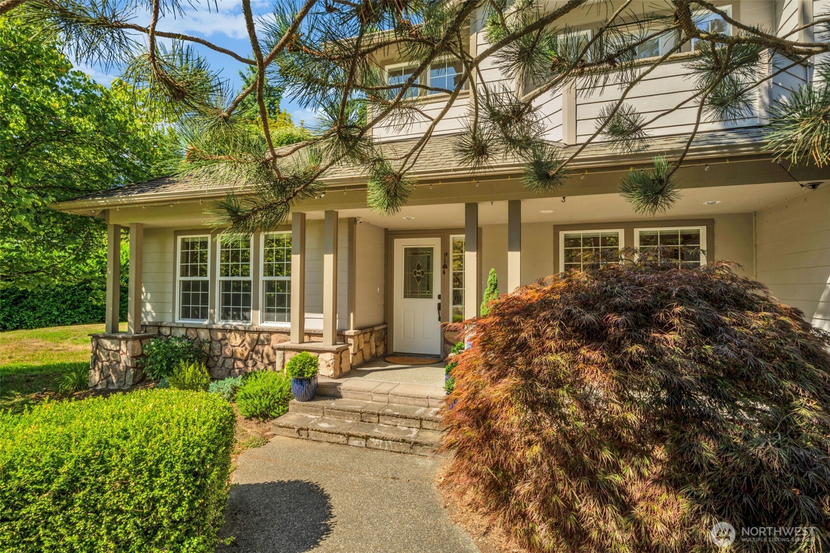 18005 252nd Avenue Southeast Maple Valley, WA 98038 - Photo 36 of 40 front view of a house with a yard and potted plants