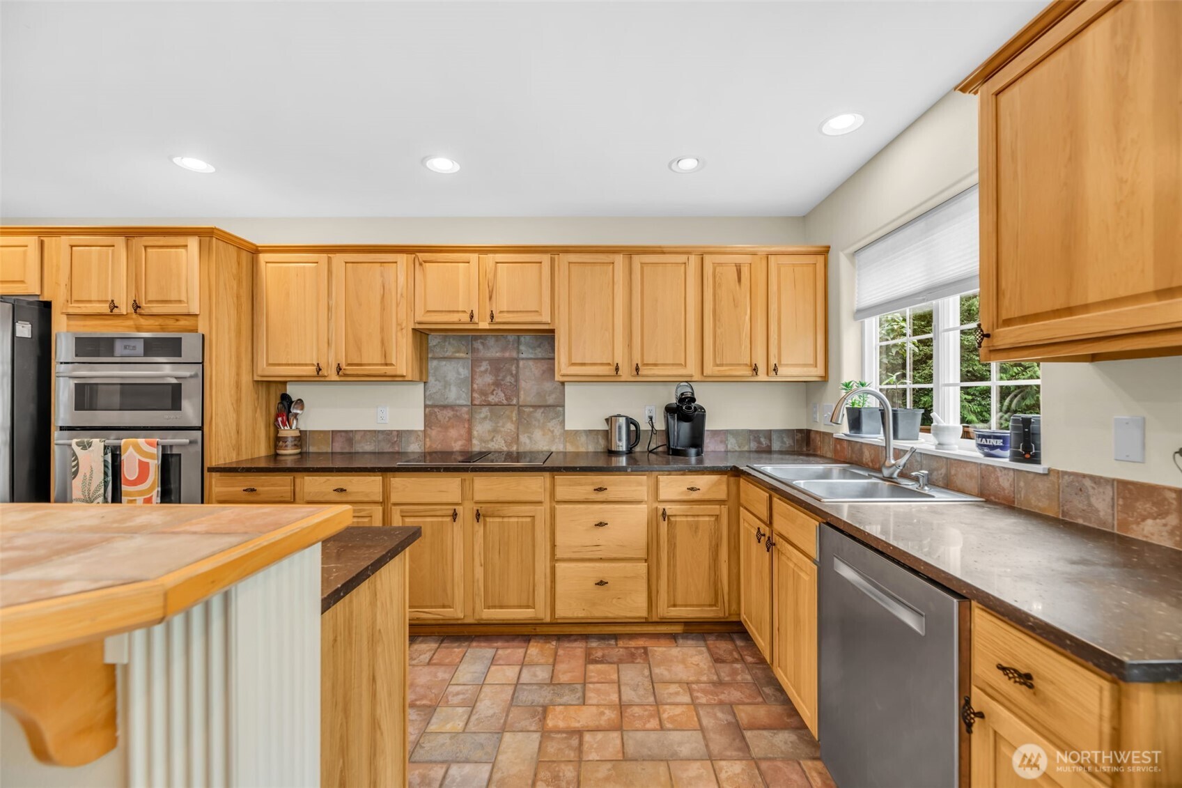 18005 252nd Avenue Southeast Maple Valley, WA 98038 - Photo 4 of 40 a kitchen with a sink stove and cabinets