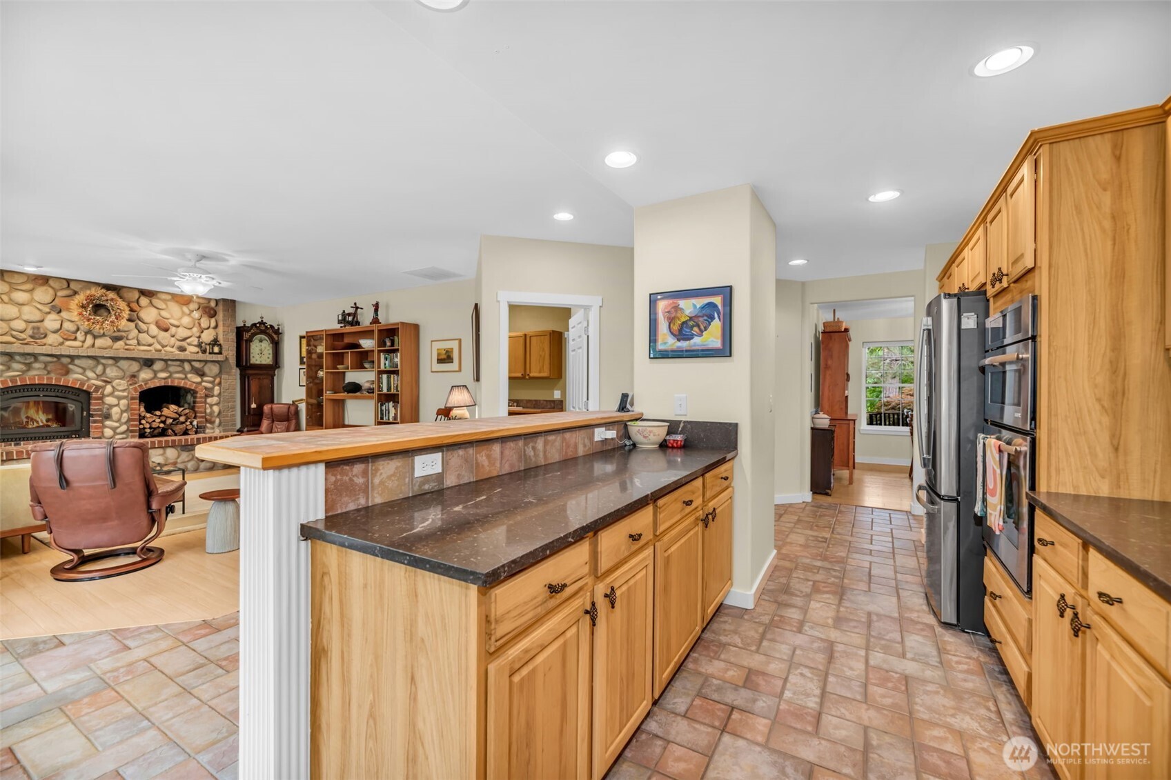 18005 252nd Avenue Southeast Maple Valley, WA 98038 - Photo 6 of 40 a kitchen with stainless steel appliances granite countertop a sink and a refrigerator