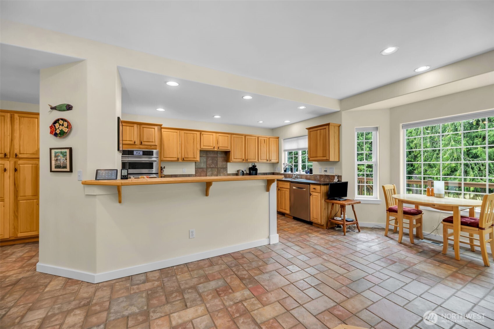 18005 252nd Avenue Southeast Maple Valley, WA 98038 - Photo 7 of 40 a view of kitchen with stainless steel appliances granite countertop a stove top oven a sink dishwasher and a refrigerator with wooden floor