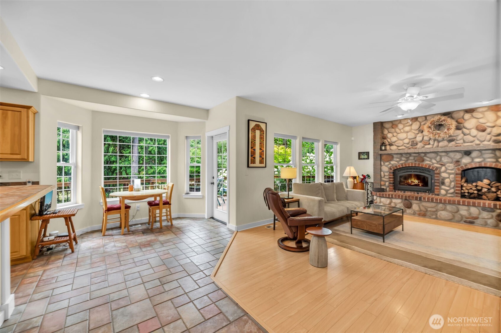 18005 252nd Avenue Southeast Maple Valley, WA 98038 - Photo 9 of 40 a living room with furniture large window and a fireplace