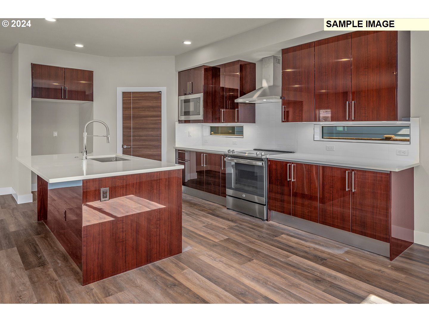 12343 Southeast Falling Rain Way Happy Valley, OR 97086 - Photo 11 of 39 a dining hall with granite countertop a sink and a wooden cabinets