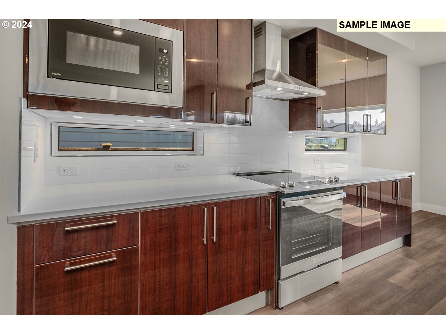 12343 Southeast Falling Rain Way Happy Valley, OR 97086 - Photo 14 of 39 a kitchen with stainless steel appliances granite countertop a stove and a microwave