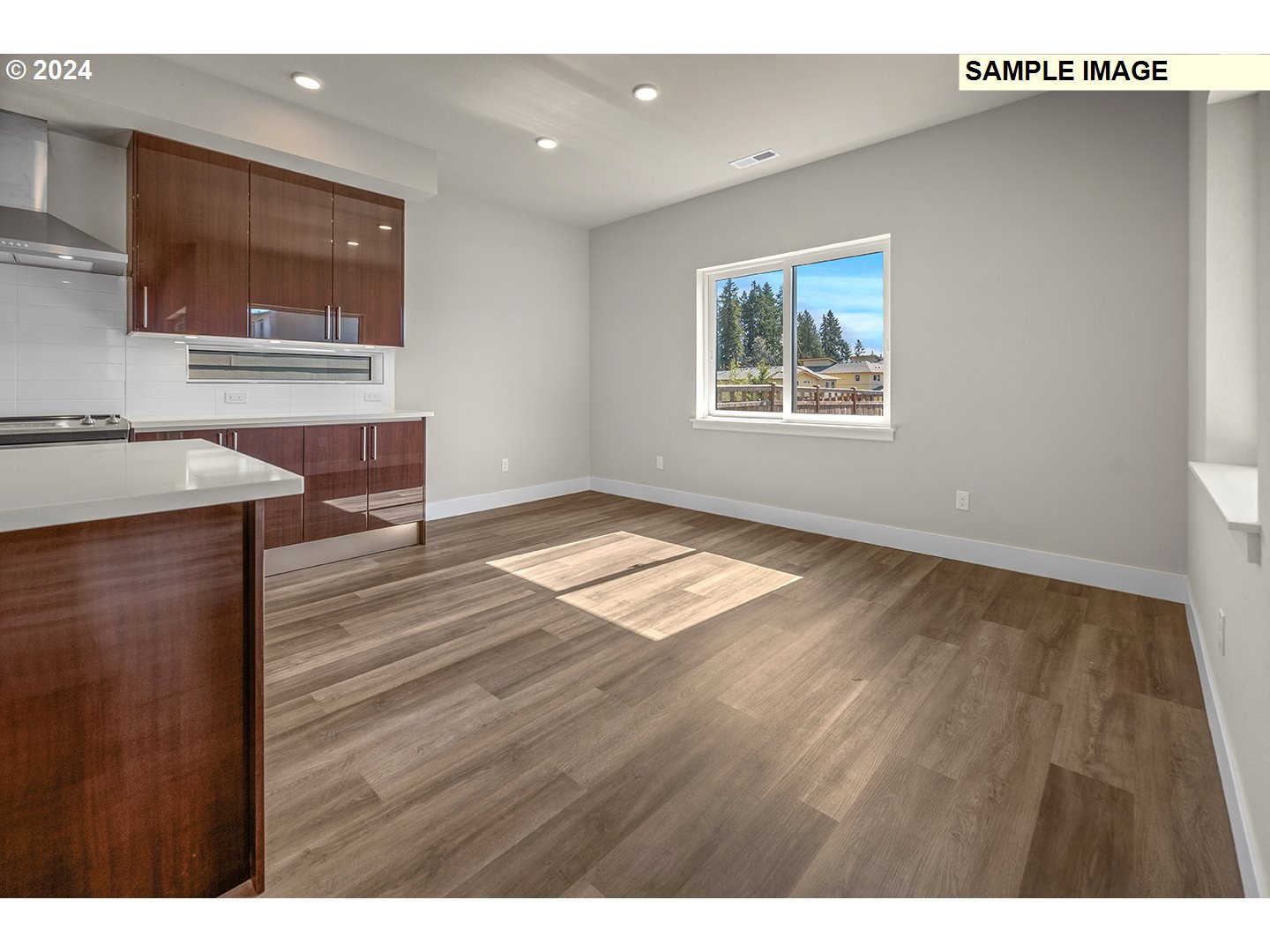 12343 Southeast Falling Rain Way Happy Valley, OR 97086 - Photo 15 of 39 a view of a kitchen with wooden floor and a window