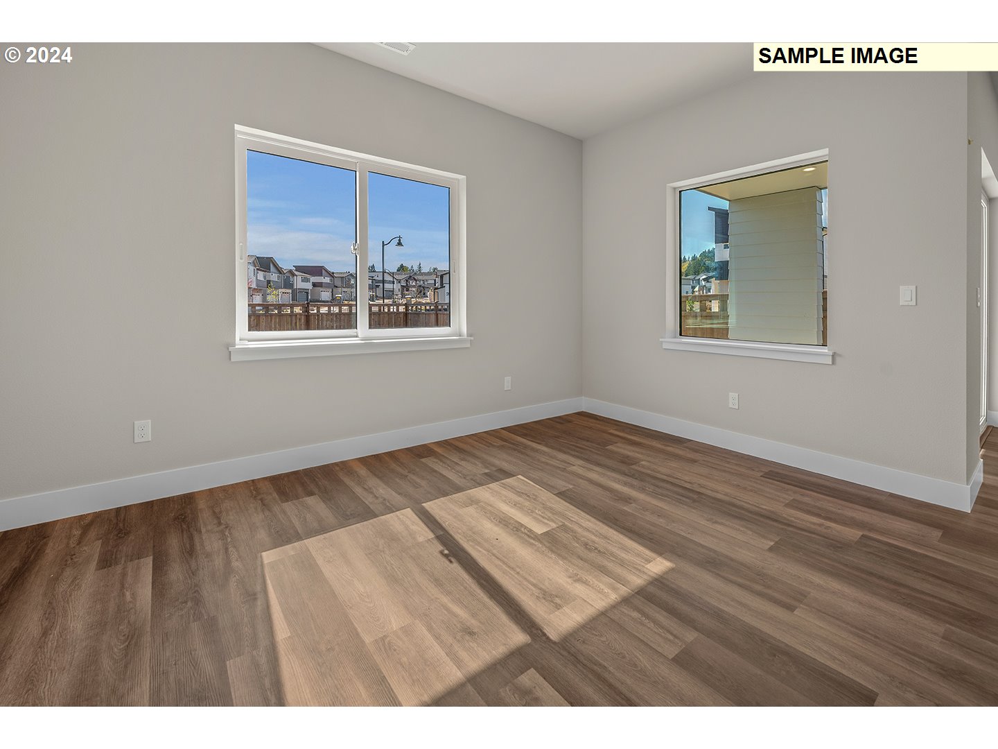12343 Southeast Falling Rain Way Happy Valley, OR 97086 - Photo 16 of 39 a view of an empty room with wooden floor and a window