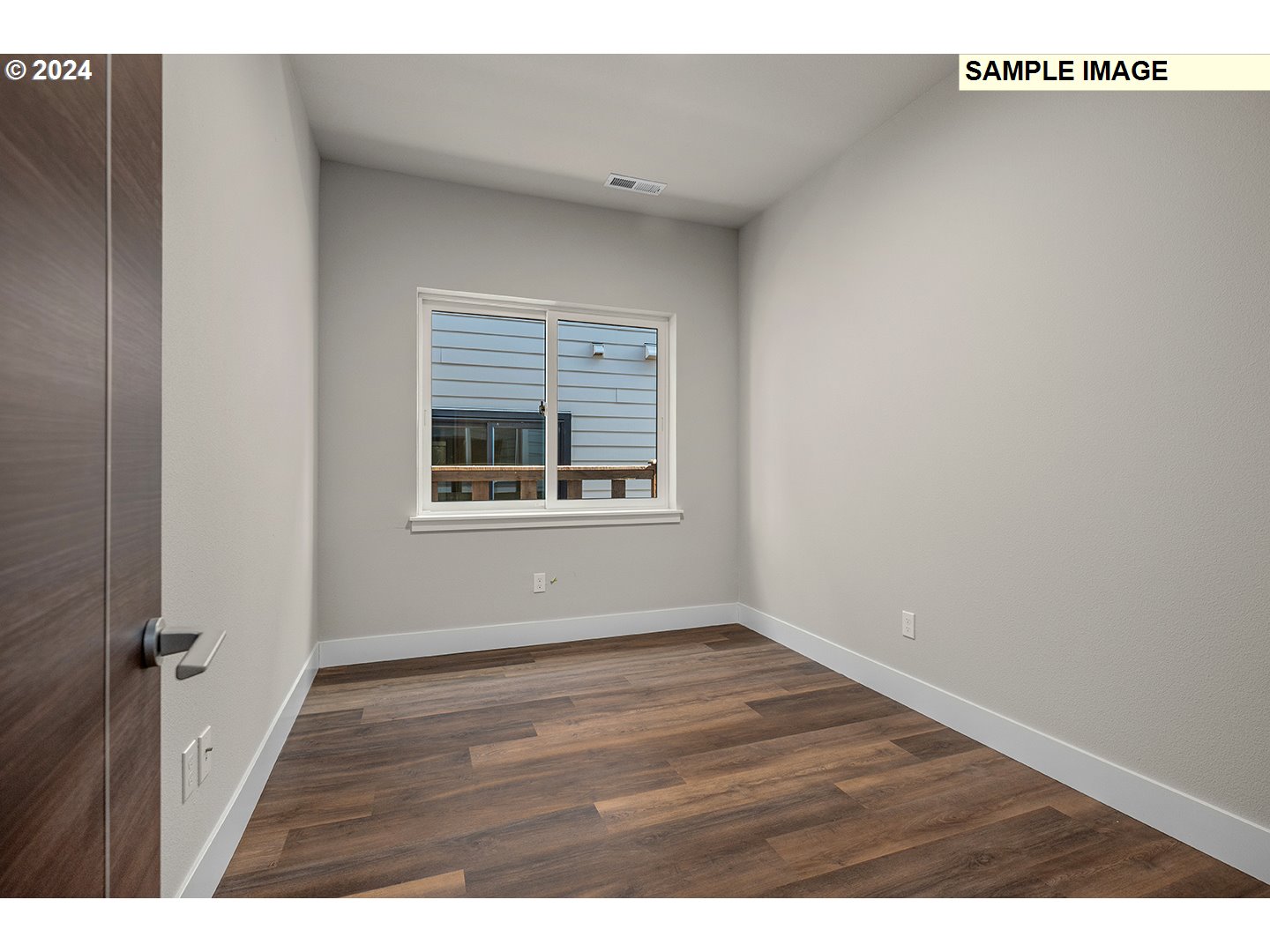 12343 Southeast Falling Rain Way Happy Valley, OR 97086 - Photo 33 of 39 a view of an empty room with wooden floor and a window